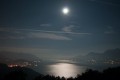 Vollmondnacht über dem See; ein paar leichte Wolken lassen das Licht diffus erscheinen